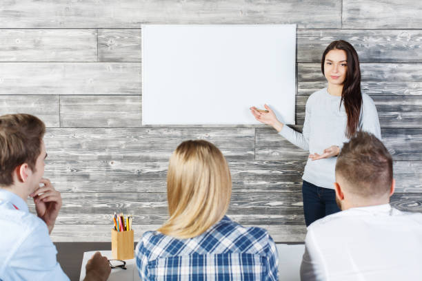 istock Pretty woman showing whiteboard 657122288