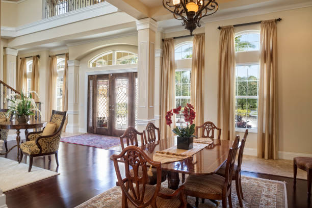 Entry to a Beautiful Estate Home Entryway to a beautiful estate home showing dining area. looking out front door stock pictures, royalty-free photos & images