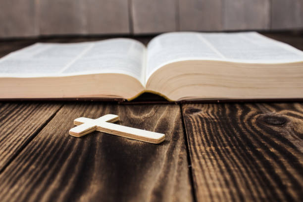 istock christian cross and bivle on wooden background 657126018