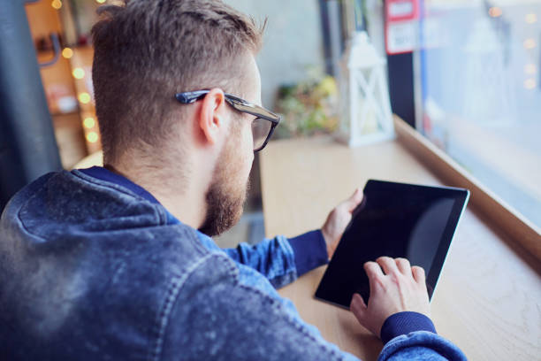 istock A freelance hipster man with  tablet in his hand works cafe by t 657126682