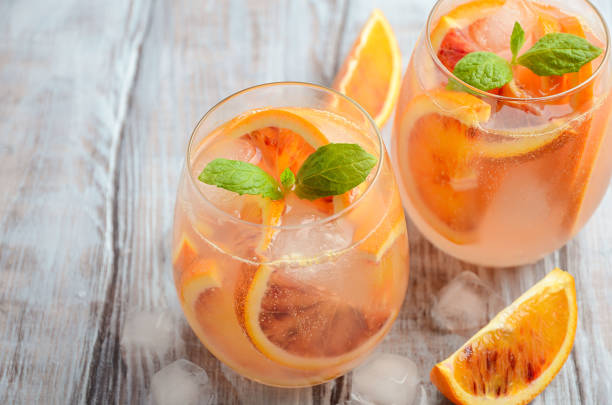 istock Cold refreshing drink with blood orange slices in a glass on a wooden background. 657126708