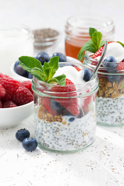 istock Breakfast in jar with chia, berries and oat flakes, vertical 657129116