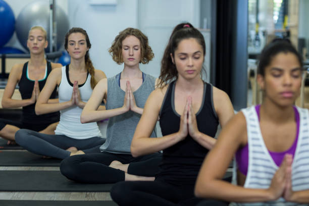 istock Group of women performing yoga 657130842