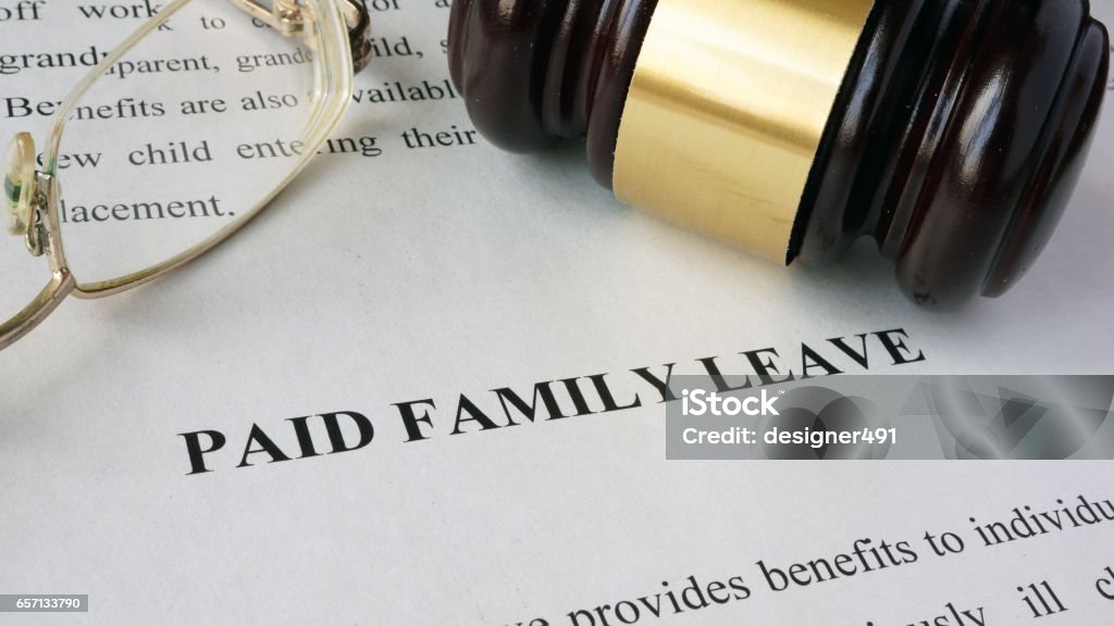 Page with title Paid family leave and gavel. Leaving Stock Photo