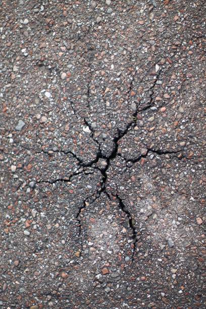istock Broken concrete anfter winter frost with a star format crack 657139368