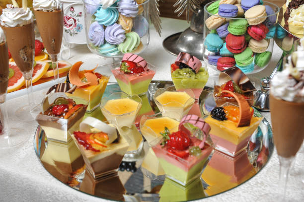 istock Wedding decoration with pastel colored cupcakes, meringues, muffins and macarons. Elegant and luxurious event arrangement with colorful macaroons. Wedding dessert with macaroons 657153910