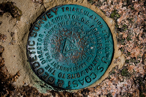 A geodetic survey marker at Acadia National Park near Bar Harbor, Maine.