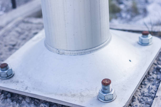 istock Larger screws into the base of a metal pillar. 657160968
