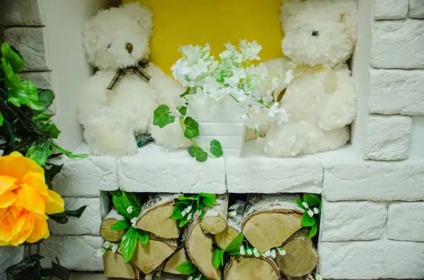 Photo of Toys with flowers in the fireplace, firewood