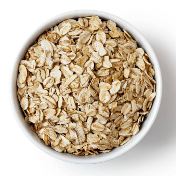 istock Dry porridge oats in white ceramic bowl isolated on white from above. 657167456