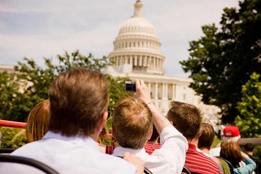 Washington, USA - May 18, 2012: Tourists on a Big Bus Tour, Washington DC, USA, people making photos of Capitol Building