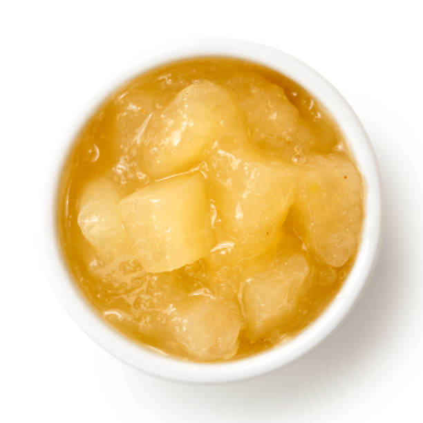 Bramley apple sauce in ceramic bowl isolated on white from above.