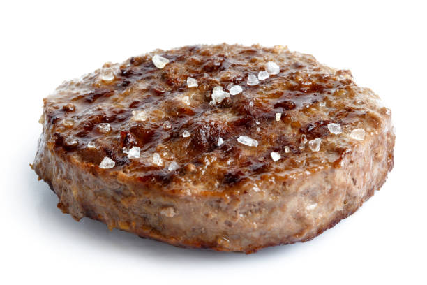 istock Single grilled hamburger patty with salt isolated on white. 657173800