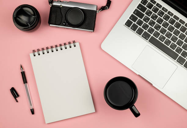istock Top view of blank notebook page on pastel colored background office desk with different objects. Minimal flat lay style 657173922