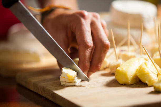 istock Staff cutting cheese at counter in market 657174232