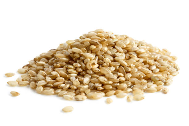 istock Pile of short grain brown rice isolated on white. 657178064