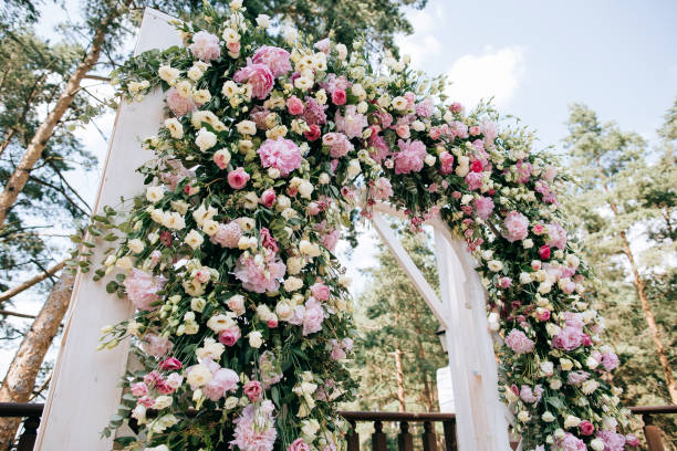istock arch for the wedding ceremony, decorated with fresh flowers in a pine forest 657181070