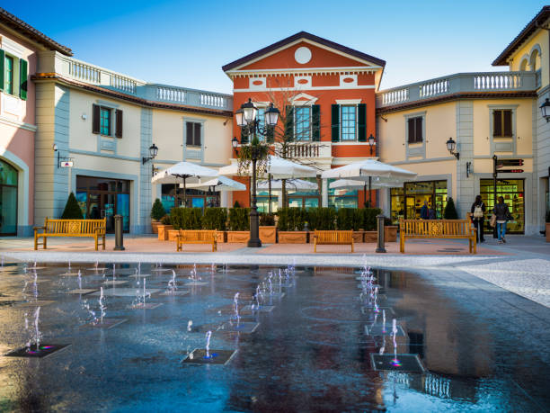 Serravalle Scrivia - March 17, 2017:  view at new part of Outlet in Serravalle Scrivia, people walking and looking shop windows stock photo