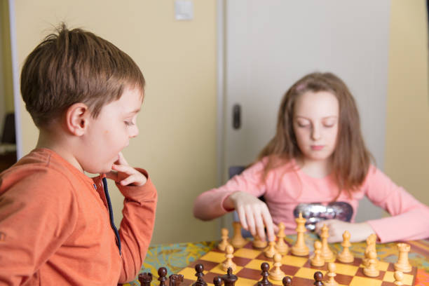 istock Brother and sister playing chess 657184888