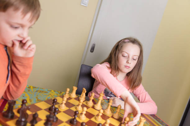istock Brother and sister playing chess 657187086