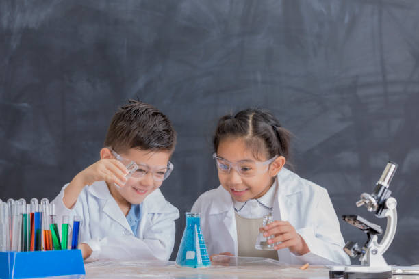 istock Cheerful STEM school kids conduct chemistry experiment 657188102