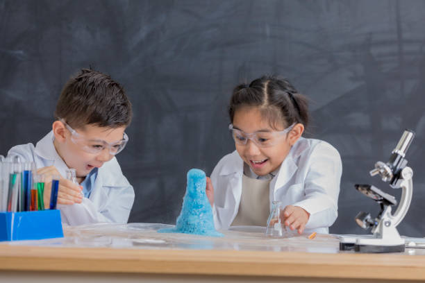 istock Excited STEM school students conduct chemistry experiment 657188108
