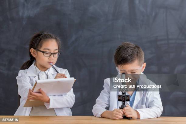 Smart School Children Use Microscope Stock Photo - Download Image Now - Asian and Indian Ethnicities, Beaker, Beauty