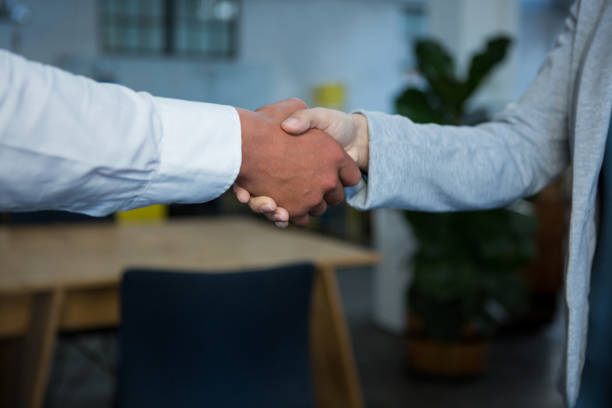 istock Close-up of businesspeople shaking hands 657188314
