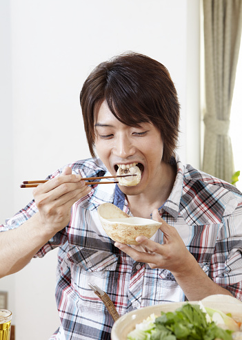 Young Man Eating Chicken Pot Stock Photo - Download Image Now - Cooking ...