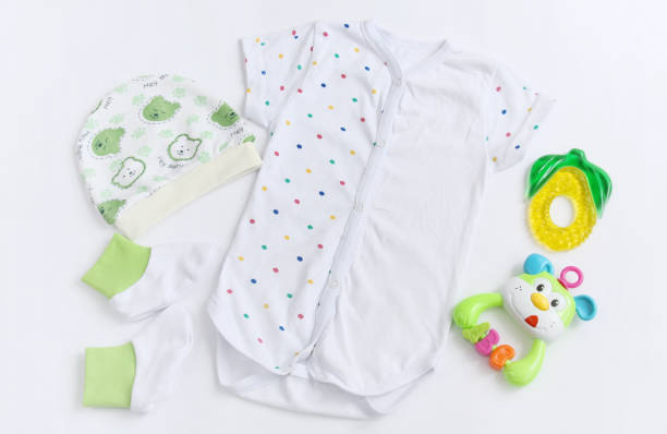istock newborn baby patterned bodysuit with hat, knitwear booties and teether 657194316