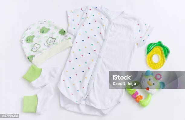 Newborn Baby Patterned Bodysuit With Hat Knitwear Booties And Teether Stock Photo - Download Image Now