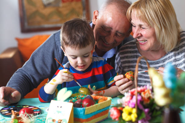 istock Grandmother and grandfather with grandson preparing eggs for Easter. 657202794
