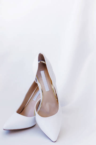 istock White wedding shoes on silk background 657203830