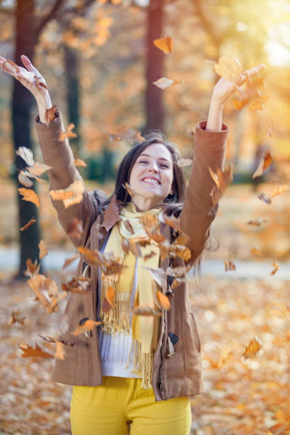 istock Joyful girl throwing autumn leaves. 657207830