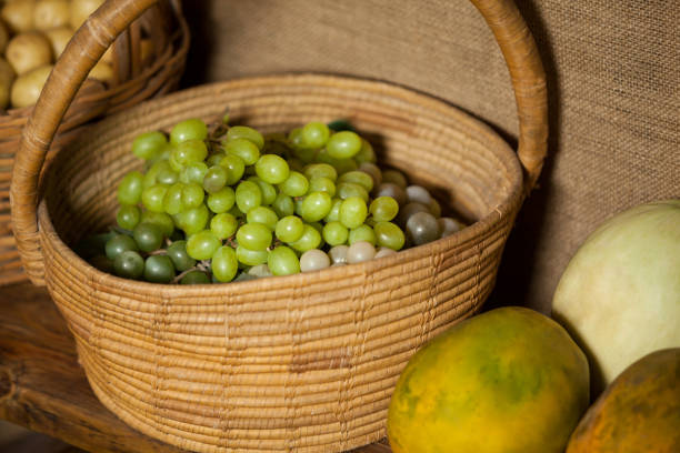 Close-up of fresh grapes in wicker basket at organic section