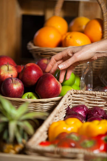 istock Hand of female staff selecting apples in organic section 657211244