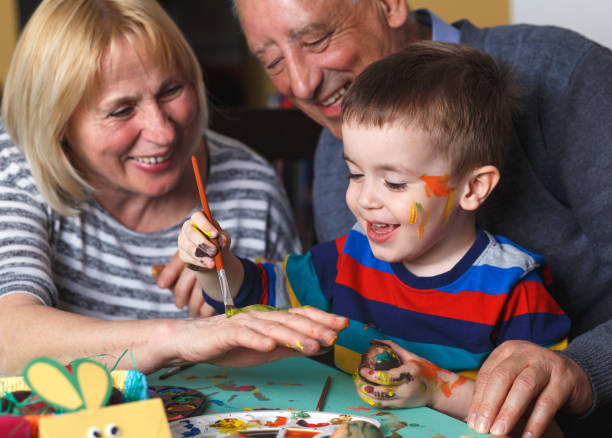 istock Grandmother and grandfather with grandson preparing eggs for Easter. 657211374