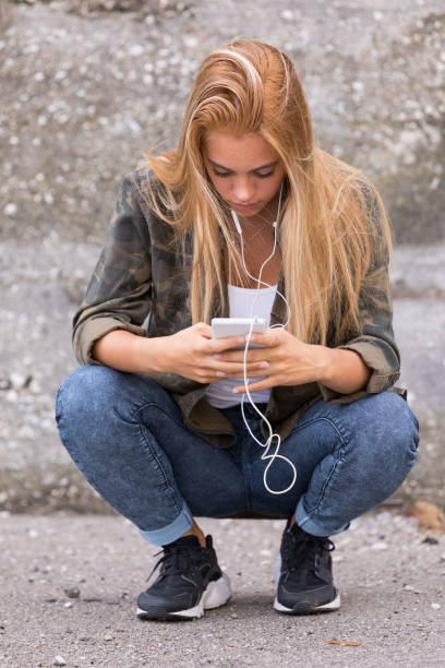 istock girl plugged into her mobile phone 657214170