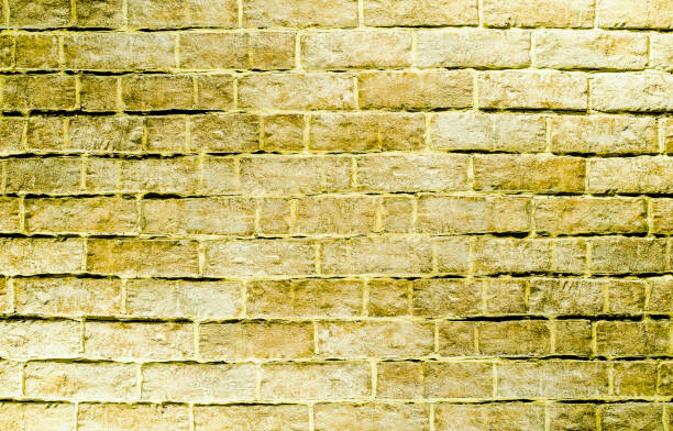 istock Golden stone wall background. brick wall background 657223422