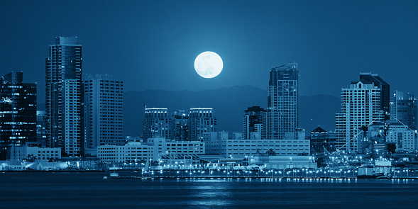 San Diego downtown skyline and full moon over water at night in BW