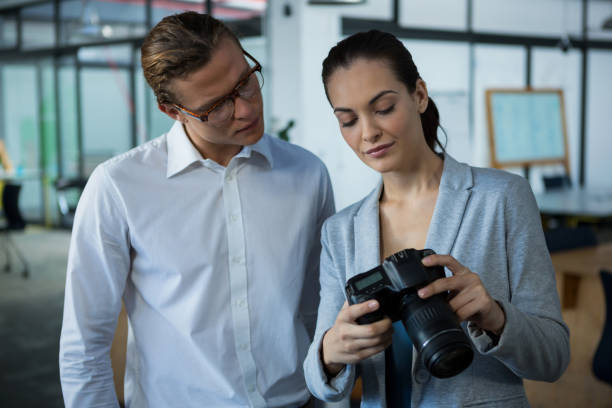 istock Graphic designer with colleague looking at digital camera 657227416