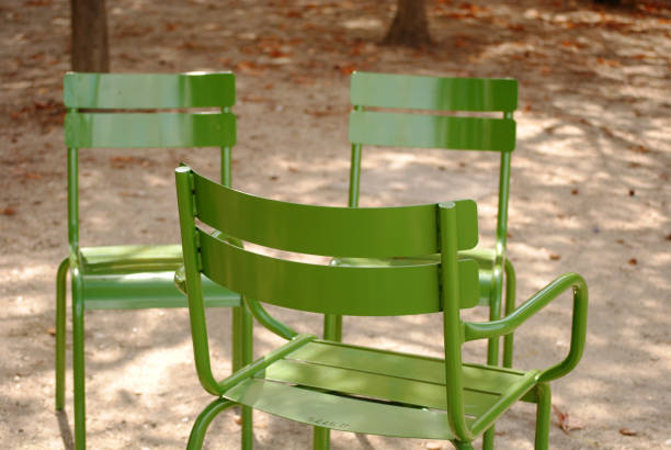 istock Empty green metal chairs in park 657233722