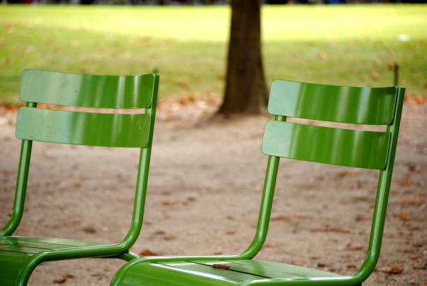 istock Empty green metal chairs in park 657233726