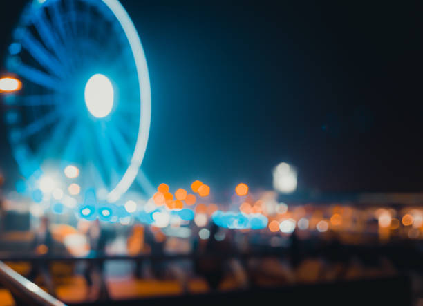 istock Abstract bokeh background of people walk on the waterfront at night 657239924