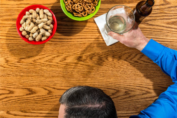 istock Overhead view of a drunk businessman at a bar 657249646
