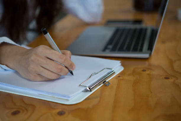 istock Female business executive writing on clipboard 657252274