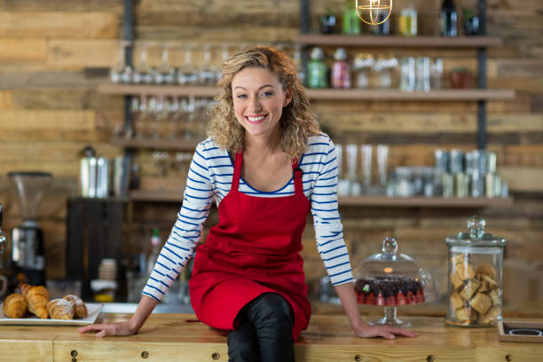 istock Portrait of waitress sitting at counter 657252364