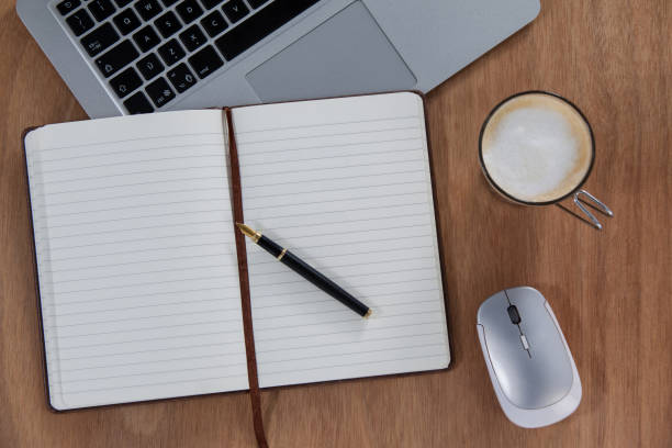 istock Cup of coffee with laptop, mouse, pen and organizer 657255348