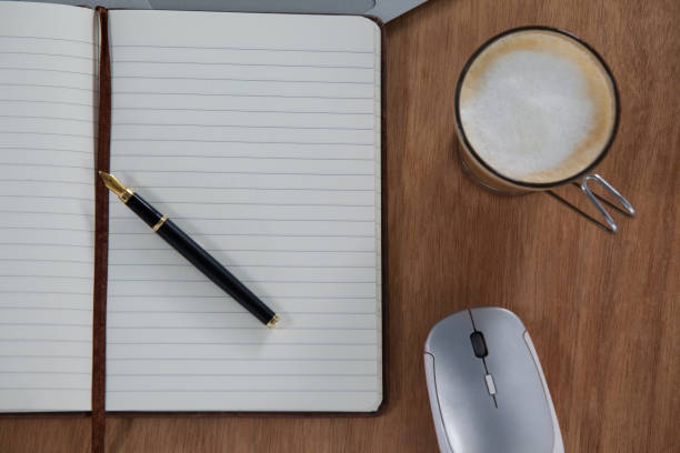 istock Close-up of coffee, oraginser, pen and mouse 657255420