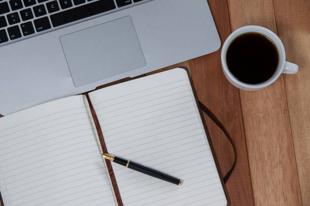 istock Cup of coffee with laptop, organizer and pen 657255432